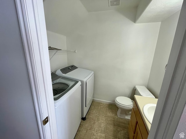 6939 S Florentine Way, West Jordan, UT 84084 - laundry area with separate washer and dryer and tile patterned flooring
