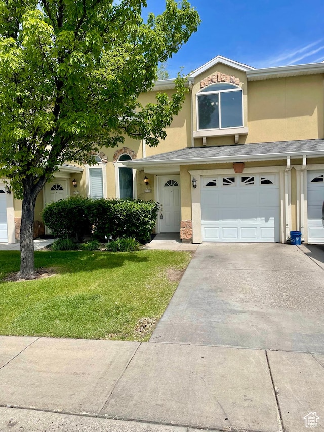 6939 S Florentine Way, West Jordan, UT 84084 - view of property featuring stucco siding, an attached garage, a front yard, and driveway