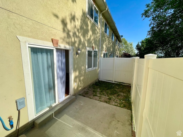 6939 S Florentine Way, West Jordan, UT 84084 - view of side of home featuring a patio area and stucco siding