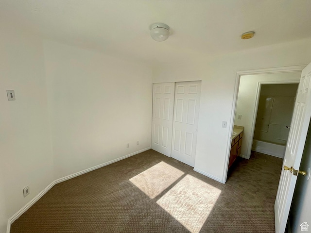 6939 S Florentine Way, West Jordan, UT 84084 - unfurnished bedroom with dark colored carpet and a closet