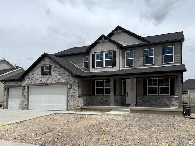 894 W Fallow Dr Unit 214, Saratoga Springs, UT 84045 - view of front of property featuring a porch, board and batten siding, concrete driveway, a garage, and stone siding
