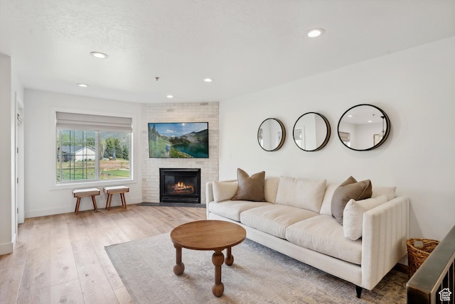 984 Uri Ln Unit 3, Midway, UT 84049 - living room featuring recessed lighting, light wood finished floors, a brick fireplace, and baseboards