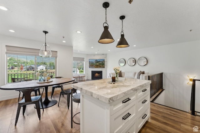 984 Uri Ln Unit 3, Midway, UT 84049 - kitchen featuring white cabinets, a center island, wood finished floors, decorative light fixtures, and recessed lighting