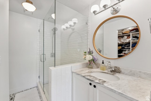 984 Uri Ln Unit 3, Midway, UT 84049 - full bath with a stall shower, vanity, a walk in closet, and tile patterned floors