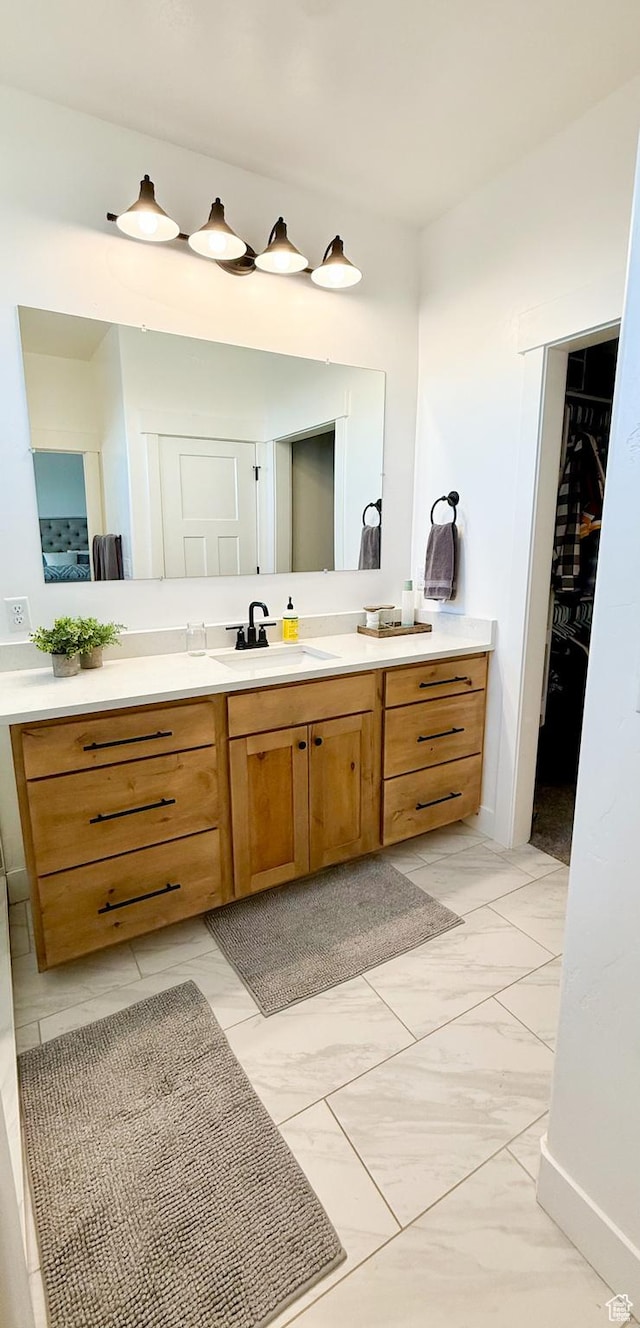 1384 E Abigail Ln, Eagle Mountain, UT 84005 - bathroom featuring marble look tile flooring, vanity, and a spacious closet