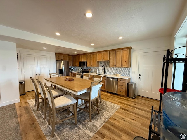 1384 E Abigail Ln, Eagle Mountain, UT 84005 - dining area with recessed lighting, light wood-type flooring, and a textured ceiling