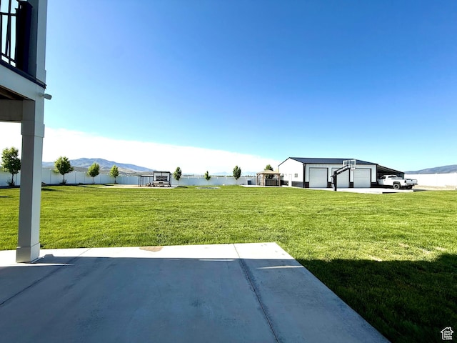 1384 E Abigail Ln, Eagle Mountain, UT 84005 - view of grassy yard with a mountain view and a detached garage