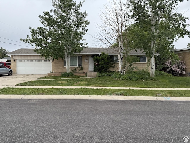 4380 S Perigrine Way, West Valley City, UT 84120 - view of front of property featuring brick siding, a garage, driveway, and a front yard
