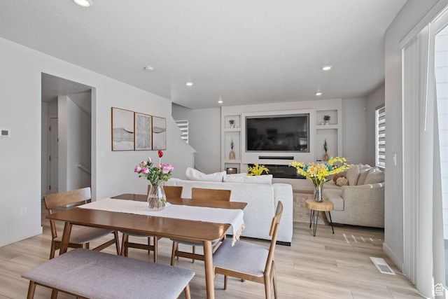 2503 N Velvet Moon Dr W Unit 636, Saratoga Springs, UT 84045 - dining space with light wood-style flooring, recessed lighting, built in shelves, and stairway