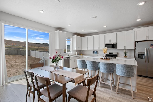 2503 N Velvet Moon Dr W Unit 636, Saratoga Springs, UT 84045 - dining space featuring light wood finished floors and recessed lighting