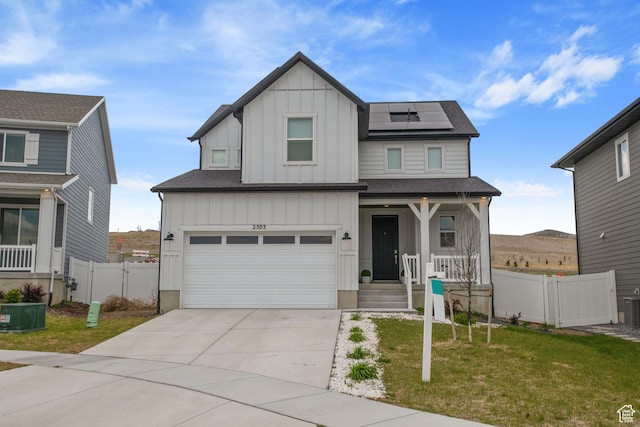 2503 N Velvet Moon Dr W Unit 636, Saratoga Springs, UT 84045 - view of front of house with board and batten siding, a porch, roof mounted solar panels, an attached garage, and concrete driveway