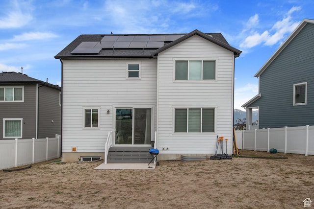 2503 N Velvet Moon Dr W Unit 636, Saratoga Springs, UT 84045 - rear view of house with entry steps, solar panels, and a fenced backyard