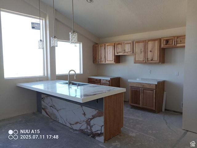 10960 N Anderson Way, Tremonton, UT 84337 - kitchen with vaulted ceiling, light countertops, decorative light fixtures, and unfinished concrete flooring