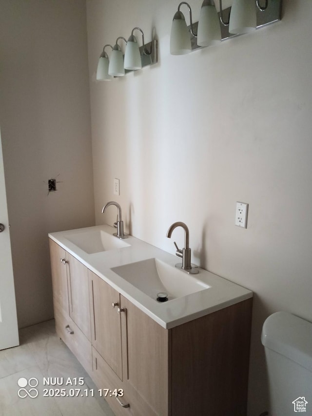 10960 N Anderson Way, Tremonton, UT 84337 - bathroom featuring toilet and double vanity