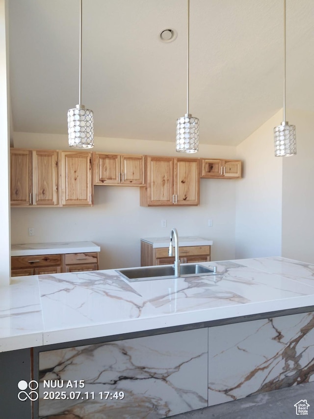 10960 N Anderson Way, Tremonton, UT 84337 - kitchen featuring lofted ceiling, light stone countertops, pendant lighting, and light brown cabinetry
