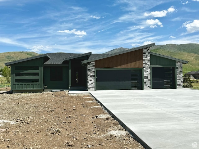 3248 E 5225 N Unit 5, Liberty, UT 84310 - view of front of house with an attached garage, a mountain view, driveway, stone siding, and roof with shingles
