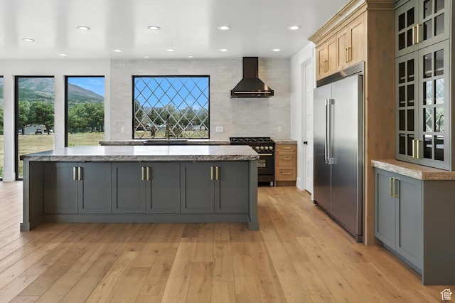 3248 E 5225 N Unit 5, Liberty, UT 84310 - kitchen featuring stainless steel built in refrigerator, wall chimney exhaust hood, range with gas cooktop, a center island, and light wood finished floors