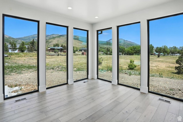 3248 E 5225 N Unit 5, Liberty, UT 84310 - unfurnished sunroom featuring a mountain view, healthy amount of natural light, recessed lighting, and wood finished floors