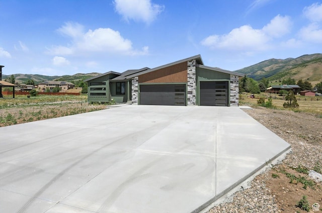 3248 E 5225 N Unit 5, Liberty, UT 84310 - view of front of home with a mountain view, stone siding, a garage, and concrete driveway