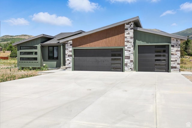 3248 E 5225 N Unit 5, Liberty, UT 84310 - view of front of house featuring stone siding, a garage, a mountain view, board and batten siding, and driveway