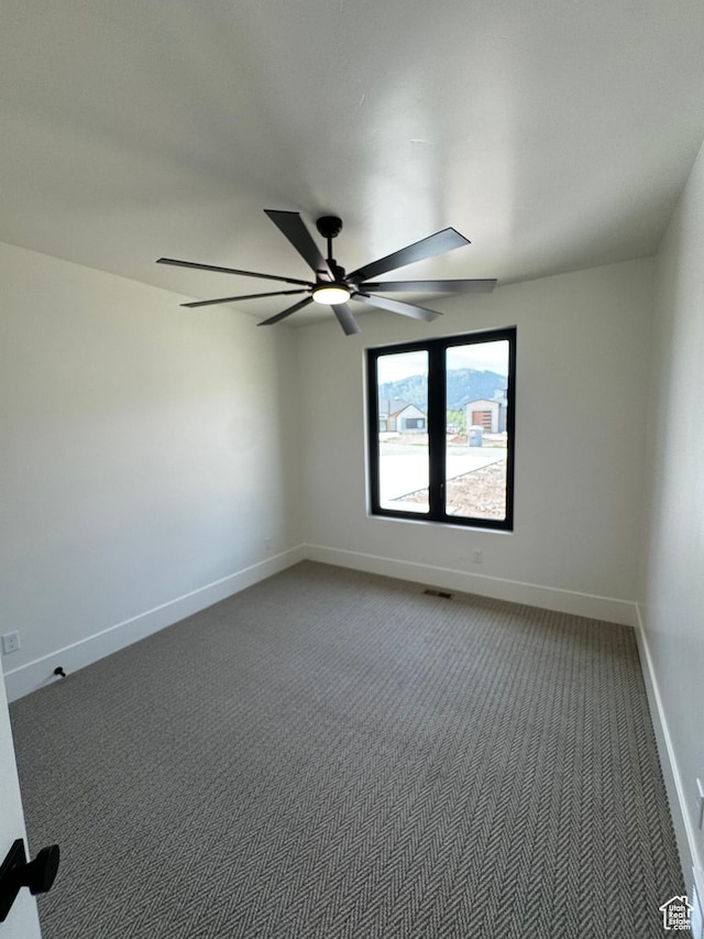 3248 E 5225 N Unit 5, Liberty, UT 84310 - empty room featuring carpet flooring, ceiling fan, and baseboards
