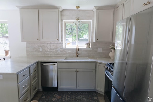 354 S 1100 E, Springville, UT 84663 - kitchen featuring appliances with stainless steel finishes, a sink, a peninsula, and white cabinetry