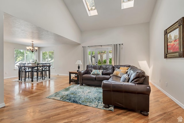 2825 Elk Horn Ln, Cottonwood Heights, UT 84093 - living room featuring a chandelier, baseboards, high vaulted ceiling, light wood finished floors, and a skylight