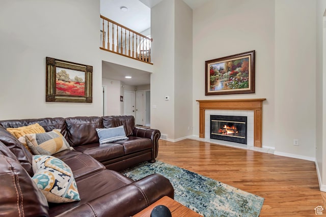 2825 Elk Horn Ln, Cottonwood Heights, UT 84093 - living room with wood finished floors, a fireplace, baseboards, and a towering ceiling