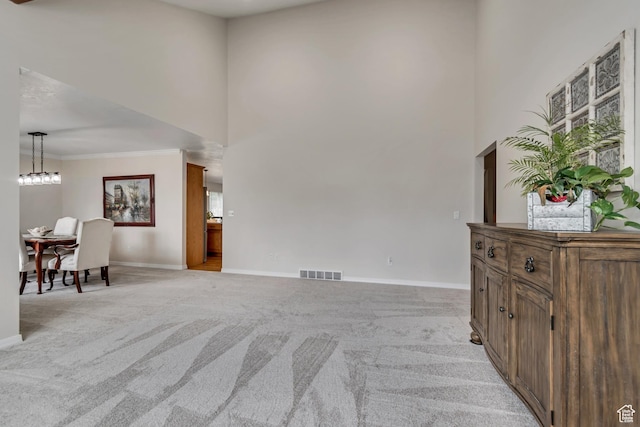 2825 Elk Horn Ln, Cottonwood Heights, UT 84093 - living room featuring light colored carpet, baseboards, a towering ceiling, healthy amount of natural light, and crown molding