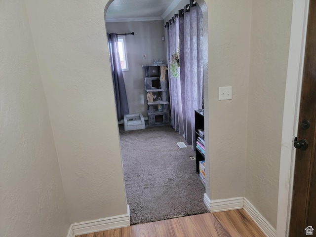 853 E 27th St, Ogden, UT 84403 - corridor featuring arched walkways, a textured wall, wood finished floors, baseboards, and ornamental molding
