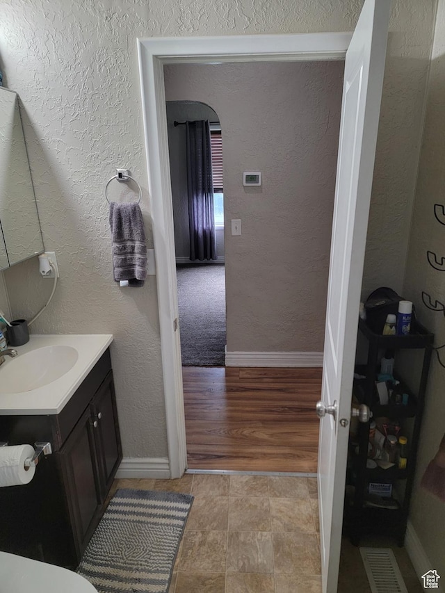 853 E 27th St, Ogden, UT 84403 - bathroom featuring vanity, a textured wall, and baseboards