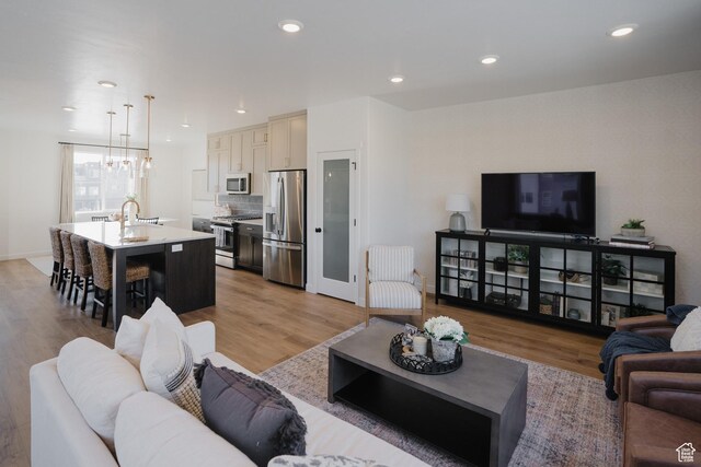 589 W 1810 N Unit 66, Salem, UT 84653 - living room with a chandelier, recessed lighting, light wood-type flooring, and baseboards