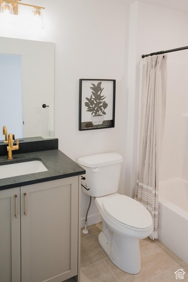 589 W 1810 N Unit 66, Salem, UT 84653 - bathroom featuring vanity, toilet, shower / tub combo with curtain, tile patterned floors, and baseboards