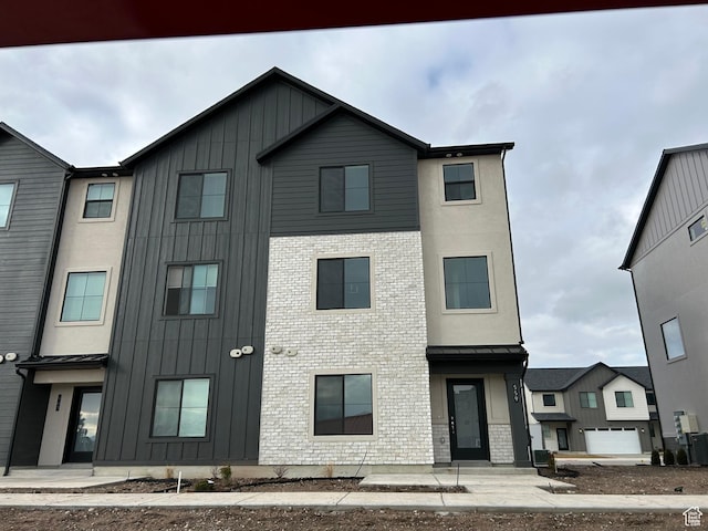589 W 1810 N Unit 66, Salem, UT 84653 - view of front facade featuring board and batten siding, brick siding, and central AC
