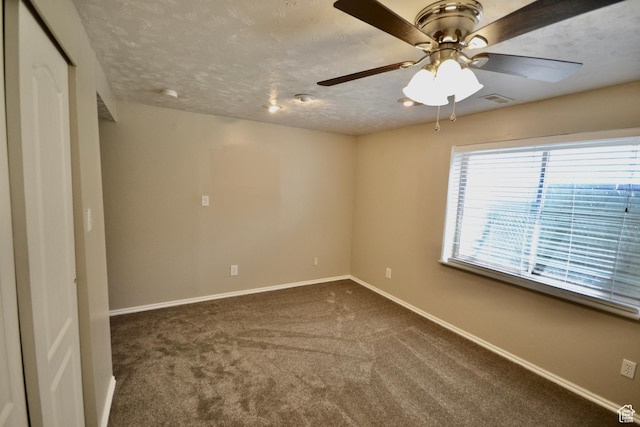5057 W 6960 S, West Jordan, UT 84081 - spare room featuring baseboards, ceiling fan, dark carpet, and a textured ceiling