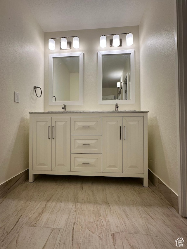 241 N Vine St W Unit 404E, Salt Lake City, UT 84103 - bathroom featuring double vanity and baseboards