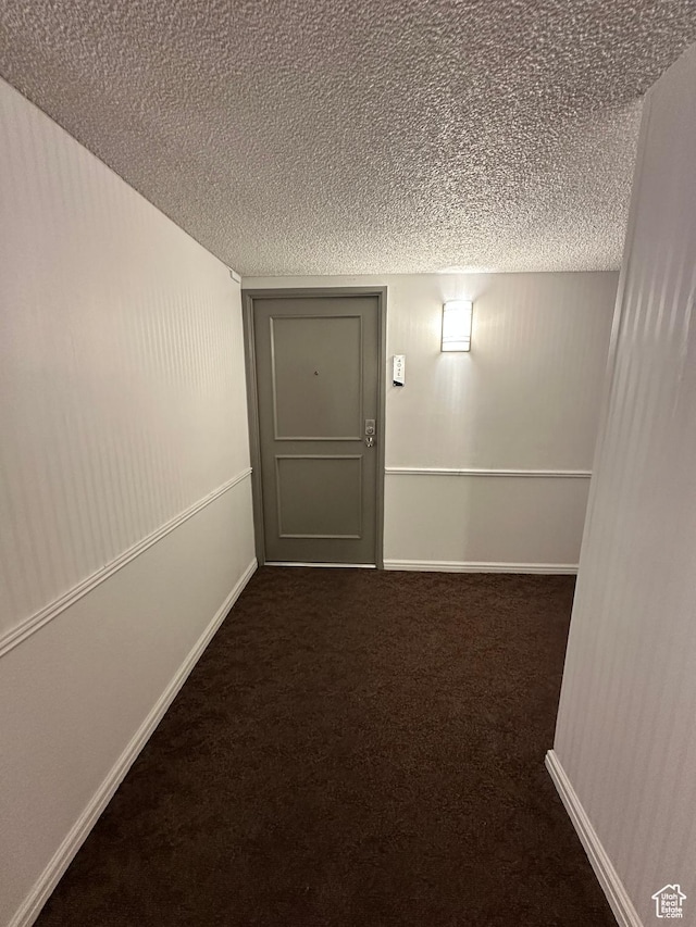 241 N Vine St W Unit 404E, Salt Lake City, UT 84103 - hall with carpet, a textured ceiling, and baseboards