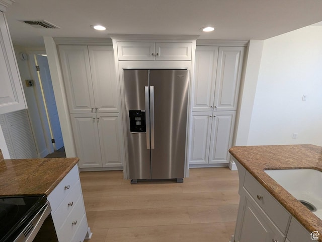 241 N Vine St W Unit 404E, Salt Lake City, UT 84103 - kitchen featuring stainless steel fridge, light wood-style floors, recessed lighting, stone countertops, and white cabinetry