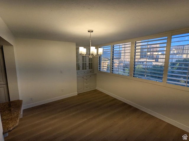 241 N Vine St W Unit 404E, Salt Lake City, UT 84103 - unfurnished dining area featuring baseboards, a chandelier, and dark wood finished floors