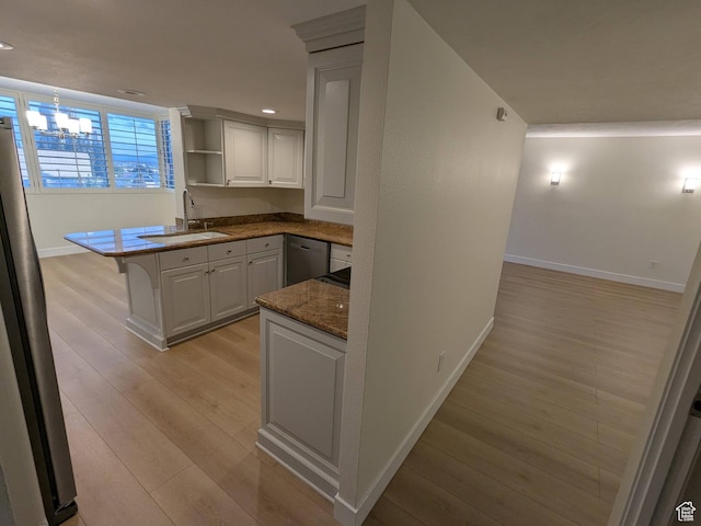 241 N Vine St W Unit 404E, Salt Lake City, UT 84103 - kitchen with baseboards, a sink, open shelves, stainless steel appliances, and light wood-style floors