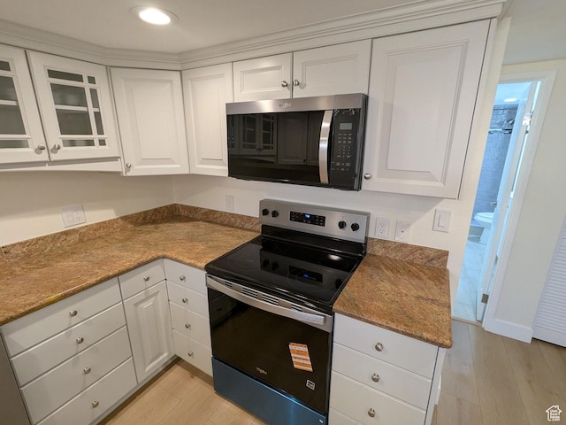241 N Vine St W Unit 404E, Salt Lake City, UT 84103 - kitchen with stainless steel microwave, range with electric stovetop, light wood finished floors, white cabinetry, and recessed lighting