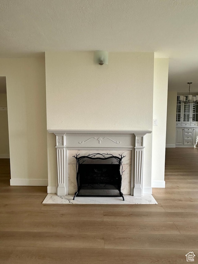 241 N Vine St W Unit 404E, Salt Lake City, UT 84103 - detailed view of wood finished floors, a fireplace with flush hearth, baseboards, and a textured ceiling