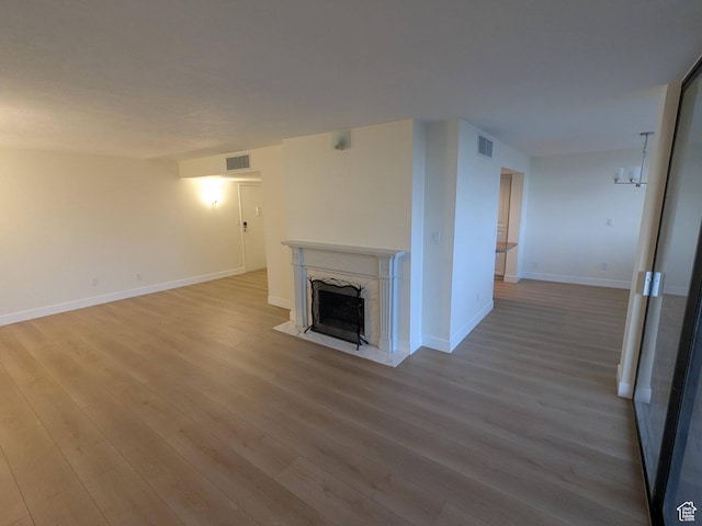 241 N Vine St W Unit 404E, Salt Lake City, UT 84103 - unfurnished living room featuring wood finished floors, a fireplace, and baseboards
