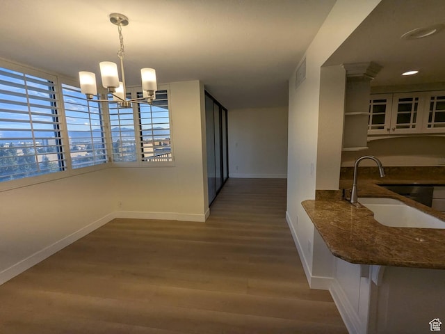 241 N Vine St W Unit 404E, Salt Lake City, UT 84103 - dining area featuring wood finished floors, baseboards, and a chandelier