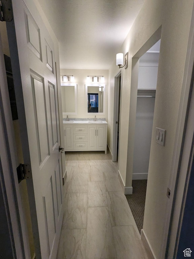 241 N Vine St W Unit 404E, Salt Lake City, UT 84103 - bathroom with marble finish flooring, double vanity, baseboards, and a spacious closet