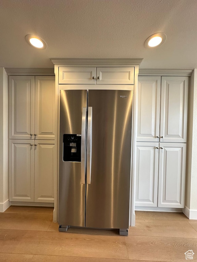 241 N Vine St W Unit 404E, Salt Lake City, UT 84103 - kitchen with stainless steel fridge, light wood-style flooring, baseboards, and a textured ceiling