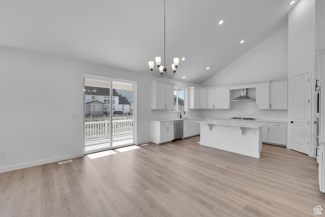 1089 S 3170 E Unit 205, Spanish Fork, UT 84660 - kitchen with wall chimney exhaust hood, stainless steel dishwasher, light countertops, a chandelier, and a center island