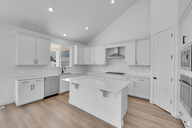 1089 S 3170 E Unit 205, Spanish Fork, UT 84660 - kitchen with stainless steel appliances, wall chimney exhaust hood, white cabinetry, light countertops, and recessed lighting