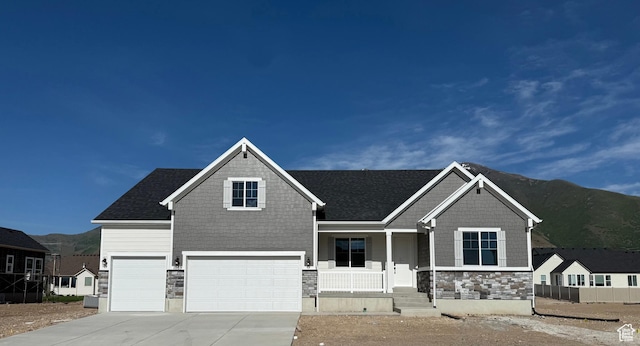 1089 S 3170 E Unit 205, Spanish Fork, UT 84660 - craftsman-style home featuring covered porch, stone siding, a mountain view, a garage, and driveway