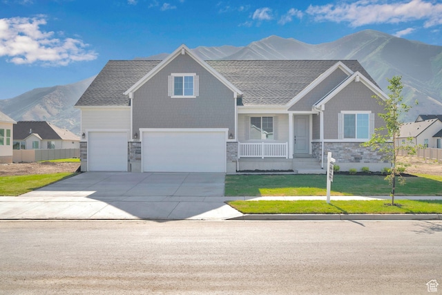 1089 S 3170 E Unit 205, Spanish Fork, UT 84660 - craftsman-style house featuring a mountain view, stone siding, a garage, concrete driveway, and a front lawn